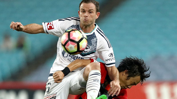 Victory defender Leigh Broxham challenges for the ball with Wanderers' Jumpei Kusukami.