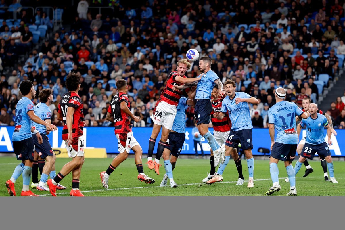 Nathan Barrie of the Wanderers competes with Alexandar Popovic of Sydney FC at Allianz Stadium.