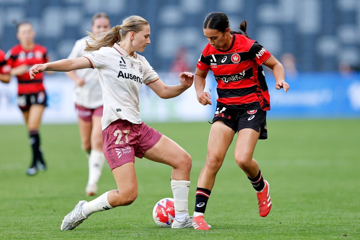 Allyssa Ng-Saad of the Wanderers competes with Rosie Curtis of the Roar at CommBank Stadium.